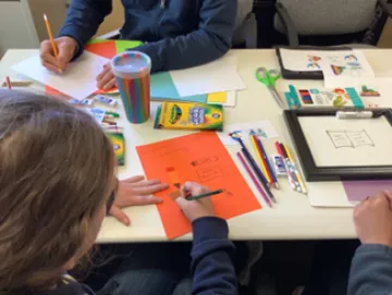 ArtWorks participants work on a new art piece