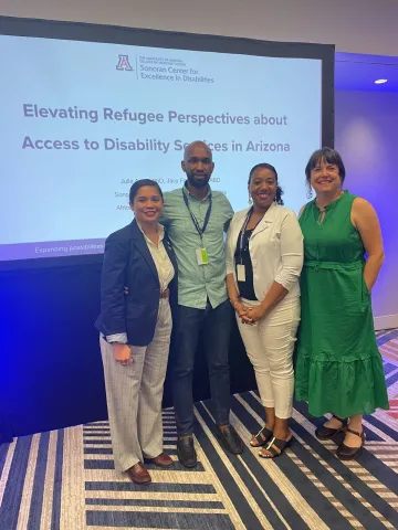 Jacy Farkas, James Nshizirungu, Venicia Mayo Burton, and Julie Armin pose for the camera after giving their presentation