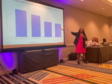 Lisa Ayo explains a graph in her and Heather Deitrich’s presentation Employment Programs for Youth and the Impact on Our Communities