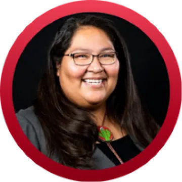 Headshot of Gabriella Cázares-Kelly, an indigenous woman with long black hair, wearing glasses.