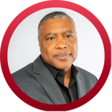 Headshot of Renaldo Fowler, a Black man with short grey hair, wearing a grey suit.