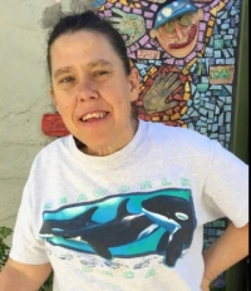 Karen wearing a orca shirt and is smiling at the camera