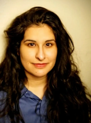 Photo of Arianne Garcia, a Hispanic woman with long brown hair and brown eyes wearing a blue shirt,