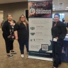Left to right: Agnes Attakai, Rosa Rojas-Franco, and Mỹ Lê Sandaine stand next to a banner for the Circle of Indigenous Empowerment